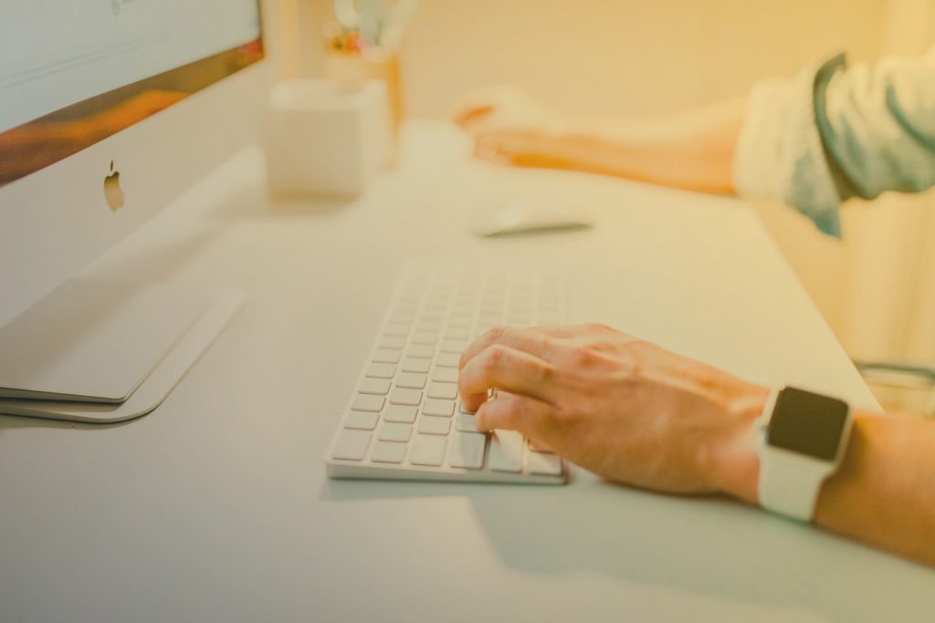 person sat at desk working on computer