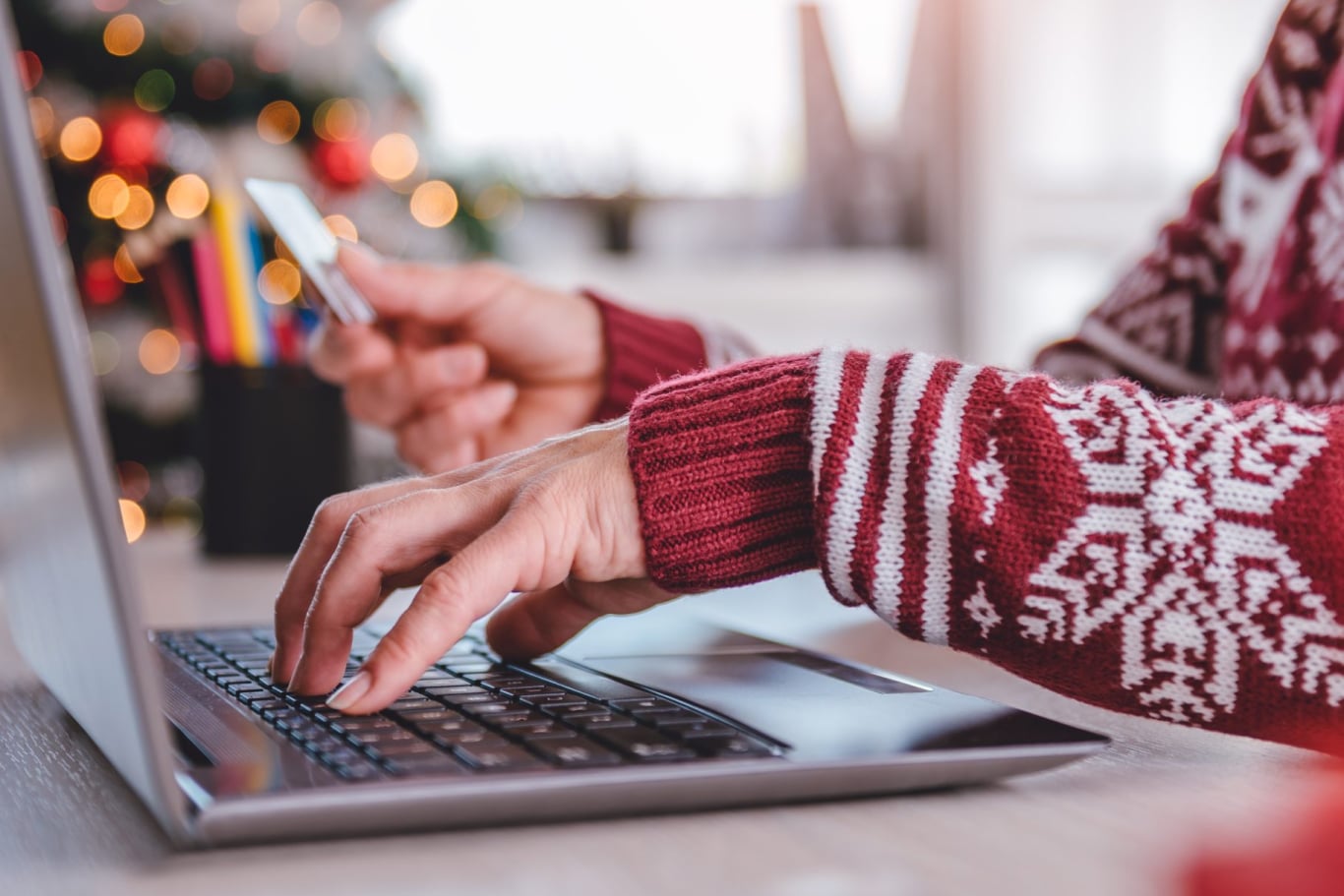 2 hands working, using a laptop