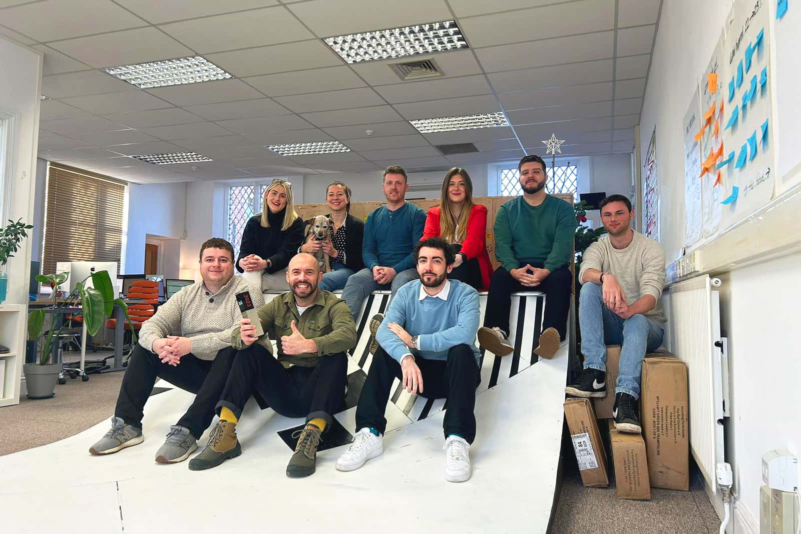 The Factory Pattern team all sat together on a skate ramp in their office after they won 2023's CRO Agency of the Year Award at the UK Agency Awards.