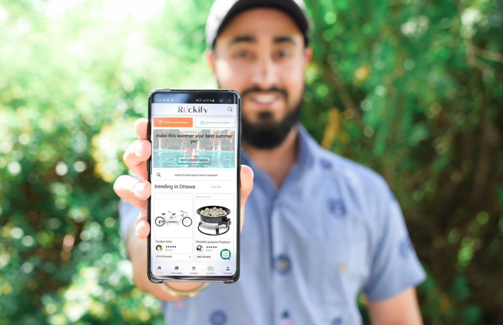 Man holding phone with website on