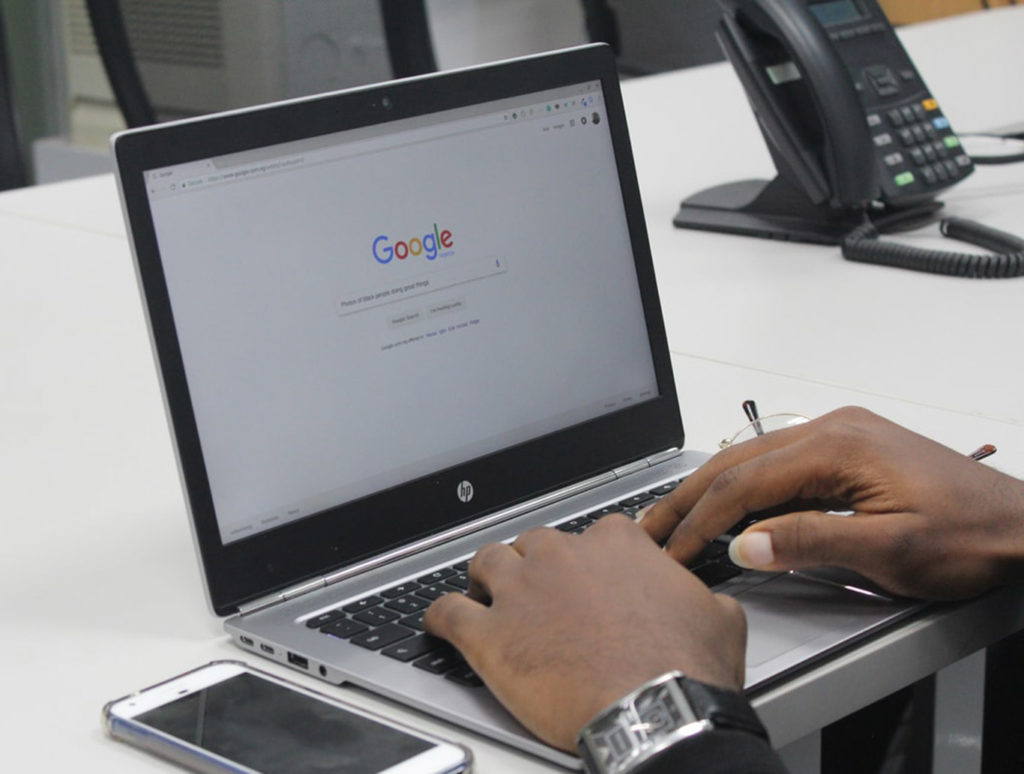 Man searching Google on his laptop
